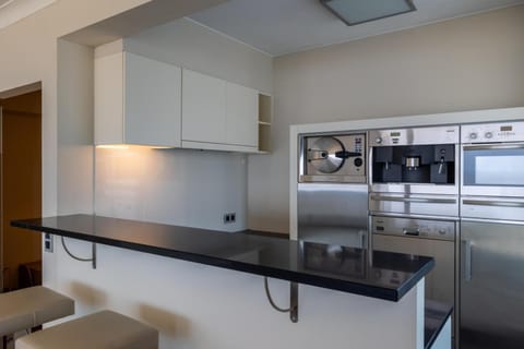 Kitchen or kitchenette, dishwasher, oven, stove