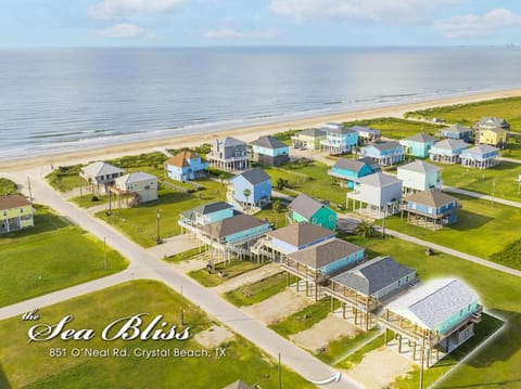 Property building, Day, Bird's eye view, Beach, Text overlay, Time of day, Location