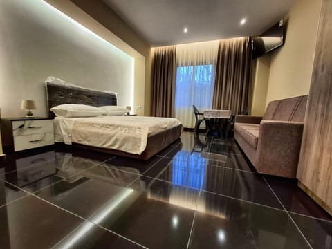 Bed, TV and multimedia, Living room, Seating area, Bedroom, hair dresser