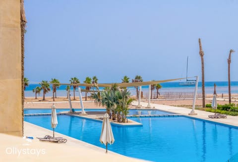 Property building, Patio, Day, Property logo or sign, Property logo or sign, Natural landscape, View (from property/room), Beach, Beach, Windsurfing, Pool view, Pool view, Sea view, Sea view, Swimming pool, sunbed, air conditioner, air conditioner