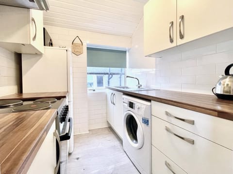 Kitchen or kitchenette, stove, washing machine