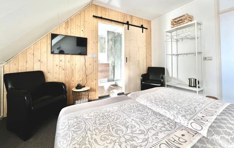 Bed, TV and multimedia, Seating area, Bedroom, hair dresser, air conditioner