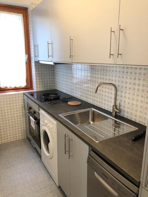 Kitchen or kitchenette, dishwasher, oven, stove, washing machine