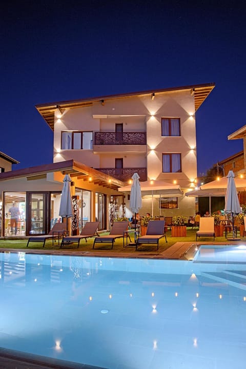 Property building, Patio, Night, Pool view, Swimming pool, sunbed