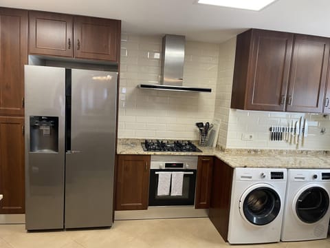 Kitchen or kitchenette, oven, washing machine, dryer