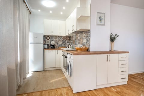 Kitchen or kitchenette, dishwasher, oven, stove, toaster, washing machine