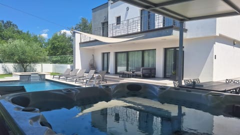 Property building, Patio, Pool view, Swimming pool, sunbed