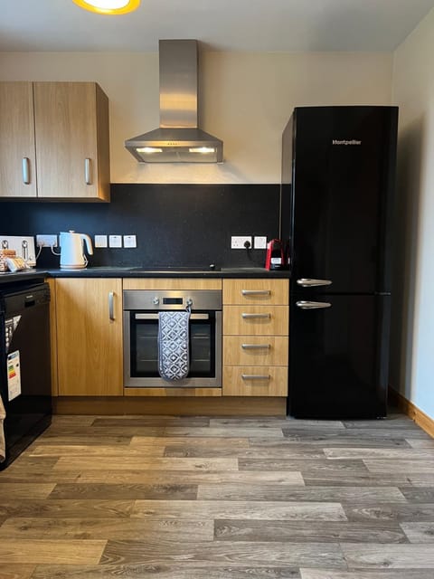 Kitchen or kitchenette, dishwasher, oven, stove