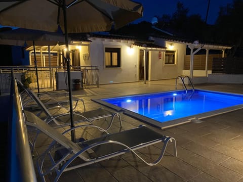 Property building, Patio, Night, Pool view, Swimming pool, sunbed