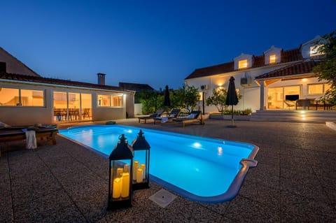 Property building, Patio, Night, Pool view, Swimming pool, sunbed