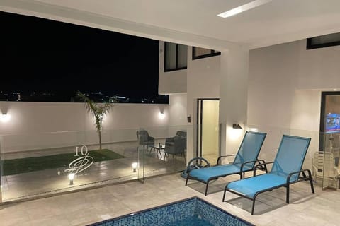 Patio, Night, Seating area, Pool view, Swimming pool, sunbed