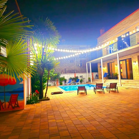 Property building, Patio, Night, Pool view, Swimming pool, sunbed