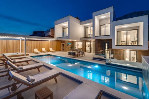 Property building, Patio, Night, Natural landscape, Pool view, Swimming pool, sunbed