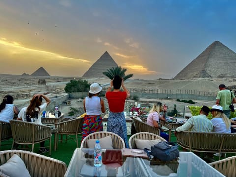 Nearby landmark, Restaurant/places to eat, People, Natural landscape, Banquet/Function facilities, Mountain view, Sunset, group of guests