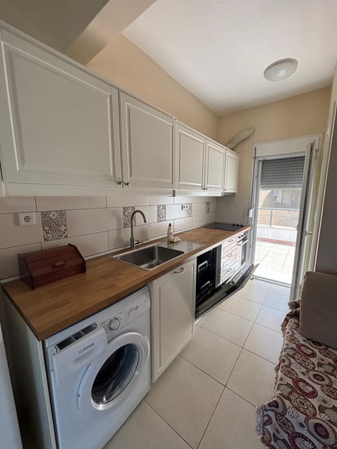 Kitchen or kitchenette, dishwasher, oven, stove, washing machine