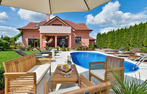 Property building, Patio, Spring, Day, Natural landscape, Garden, Living room, Seating area, Garden view, Pool view, Swimming pool