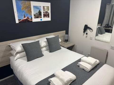 Bed, hair dryier, towels