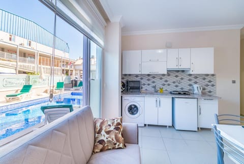 Kitchen or kitchenette, Living room, Seating area, Dining area, Pool view, Swimming pool, washing machine