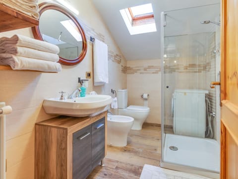 Shower, Toilet, Bathroom, bidet, hair dryier, towels, washing machine