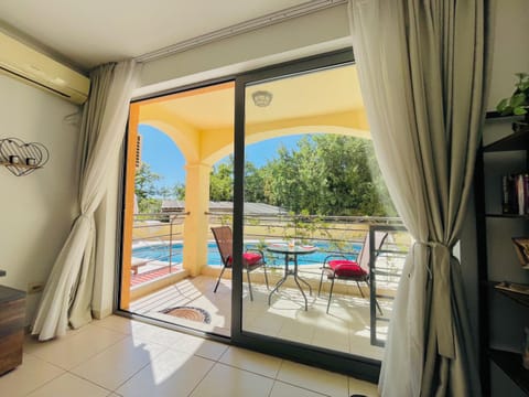 View (from property/room), Balcony/Terrace, Seating area, Pool view, Swimming pool