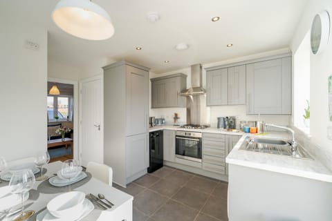 Kitchen or kitchenette, dishwasher, oven, stove