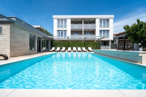 Property building, Pool view, Swimming pool, sunbed