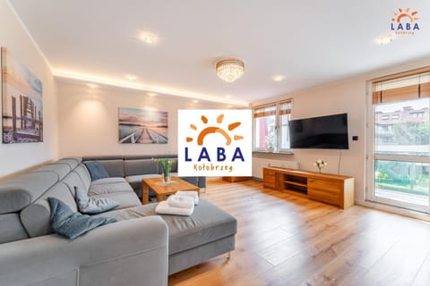 Communal lounge/ TV room, Property logo or sign, TV and multimedia, Living room, Seating area, Evening entertainment