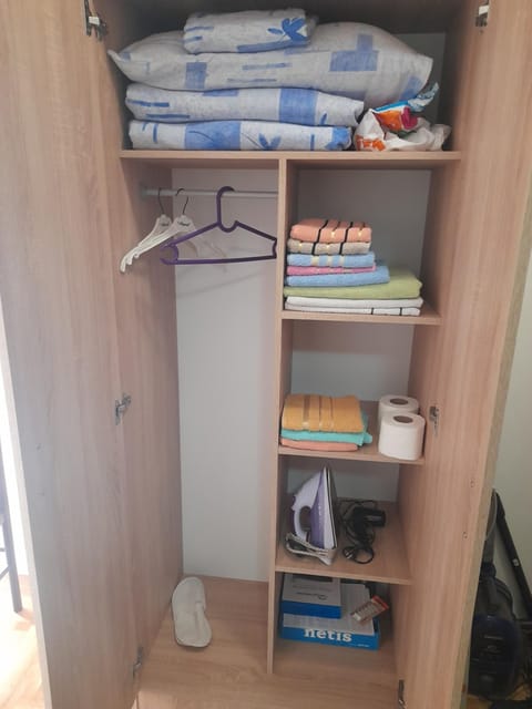 Text overlay, furniture, towels, wardrobe