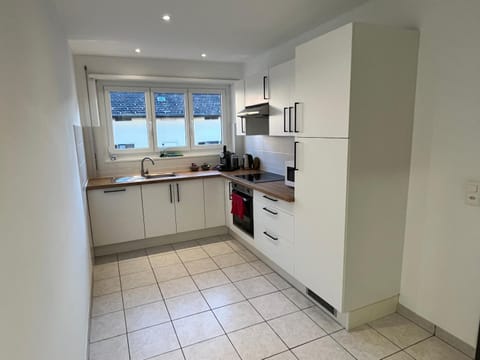 Kitchen or kitchenette, dishwasher, oven, stove