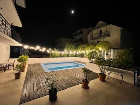 Property building, Patio, Night, Pool view, Swimming pool