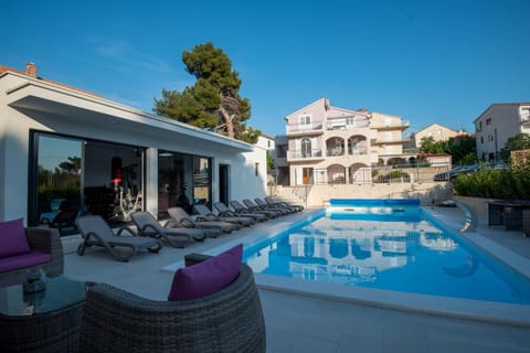 Property building, Patio, Day, Natural landscape, Seating area, Pool view, Swimming pool, sunbed
