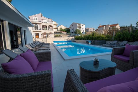 Property building, Patio, Day, Natural landscape, Seating area, Pool view, Swimming pool, sunbed