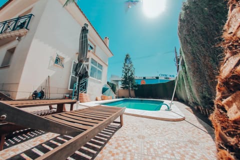 Property building, Patio, Day, Natural landscape, Pool view, Swimming pool, sunbed