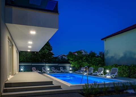 Property building, Patio, Night, Pool view, Swimming pool, sunbed