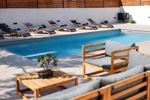 Patio, Day, Seating area, Pool view, Swimming pool, sunbed