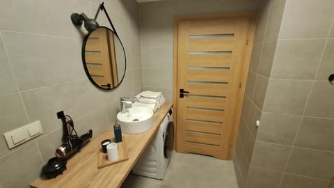 Bathroom, hair dryier, towels, washing machine