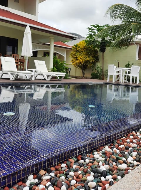 Property building, Patio, Pool view, Swimming pool, sunbed