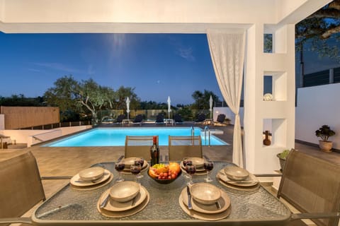 Property building, Patio, Seating area, Dining area, Swimming pool, sunbed