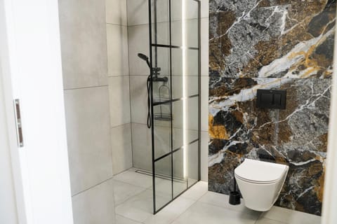 Shower, Toilet, Bathroom, flat iron, hair dryier, towels, laundry, washing machine, dryer