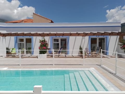 Property building, Patio, Pool view, Swimming pool, sunbed