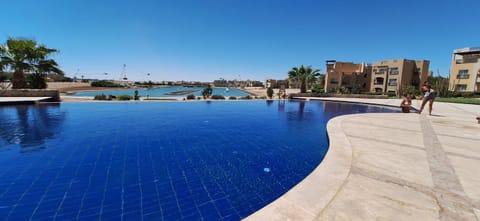 Property building, Nearby landmark, Day, People, Pool view, Swimming pool, group of guests, sunbed