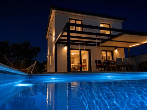 Property building, Patio, Night, Swimming pool, sunbed