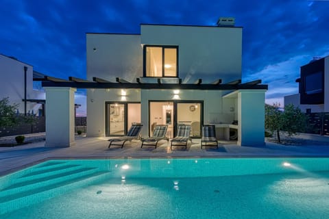 Property building, BBQ facilities, Seating area, Swimming pool, Sunset