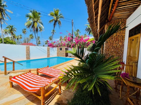 Patio, Day, Pool view, sunbed