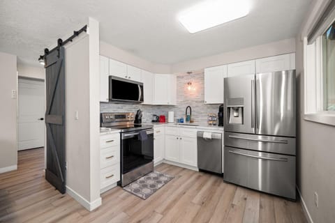 Kitchen or kitchenette, dishwasher, microwave, oven, stove