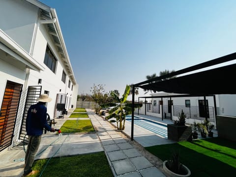 Property building, Garden, Pool view, Swimming pool, sunbed