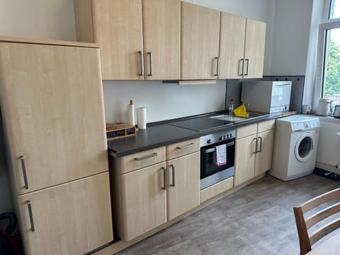 Kitchen or kitchenette, dishwasher, oven, stove, toaster, washing machine