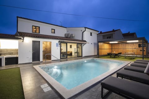 Property building, Patio, Night, Swimming pool, sunbed