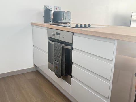 Kitchen or kitchenette, dishwasher, oven, stove, washing machine