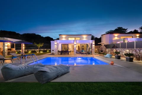 Property building, Patio, Night, Swimming pool, sunbed